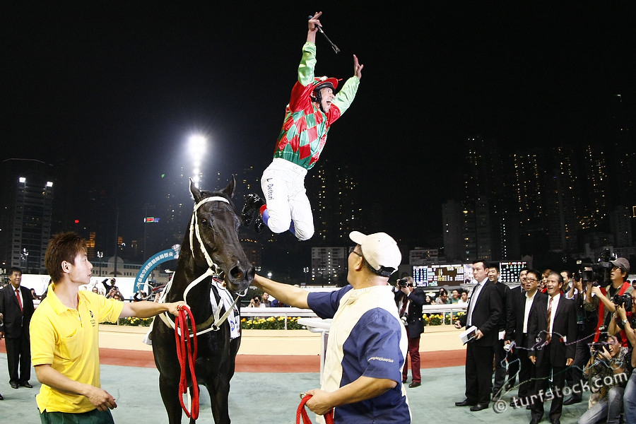 07. Dec. 2011 - Happy Valley Racecourse; Lanfranco Dettori jumps off Regency Winner after he wins the final leg to the Cathay Pacific International Championship. Credit: Lajos-Eric Balogh/turfstock.com
